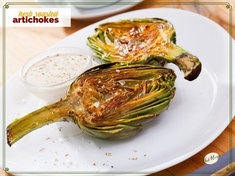 artichoke halves on a plate with dipping sauce ad text overlay "herb roasted artichokes"