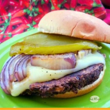 burger topped with chili and grilled red onion slice