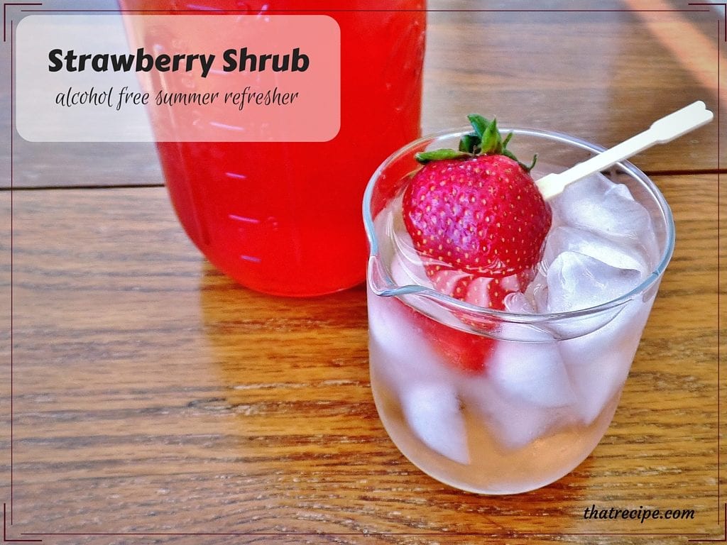 Iced drink with a fresh strawberry on a table